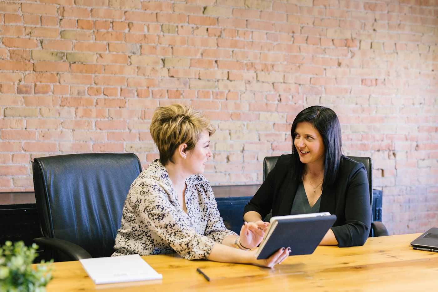 Two women working through a marketing plan together at a table